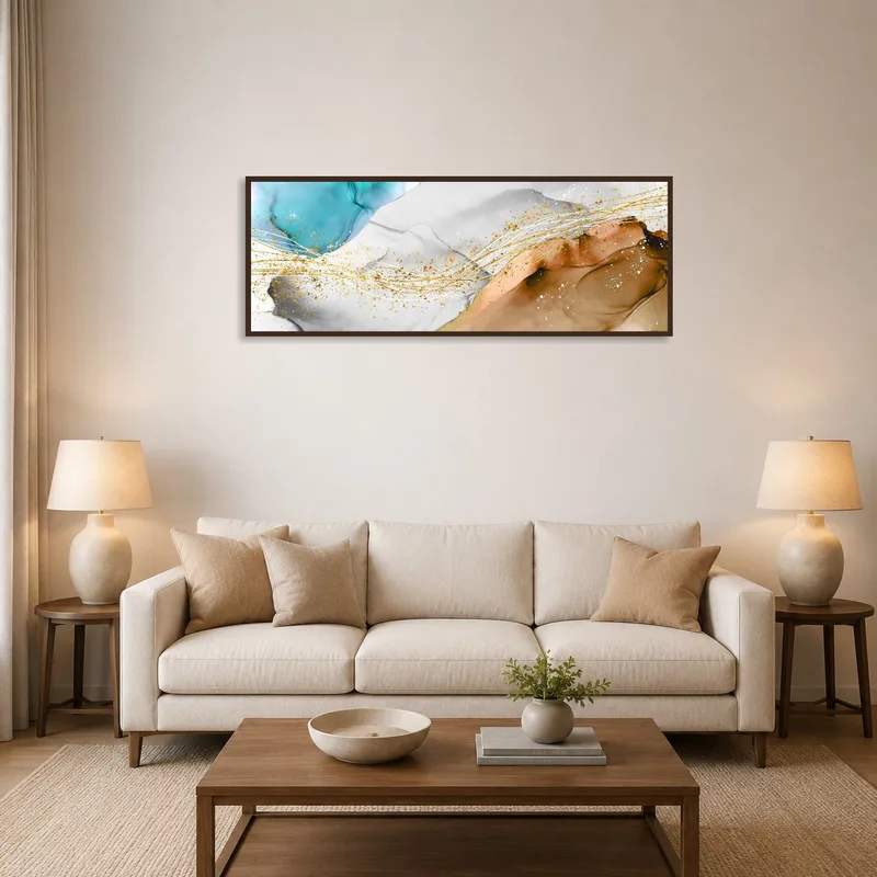Abstract panoramic art with gold accents on a living room wall above a modern sofa.