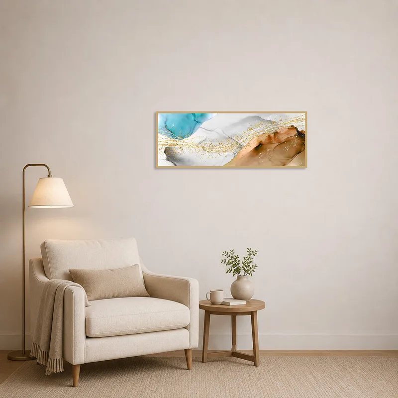Reading corner with a cozy armchair and abstract panoramic art with gold accents hanging nearby.
