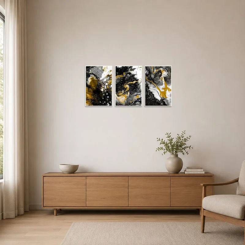 Minimalist space with abstract triptych in gold, black, and white against white walls.
