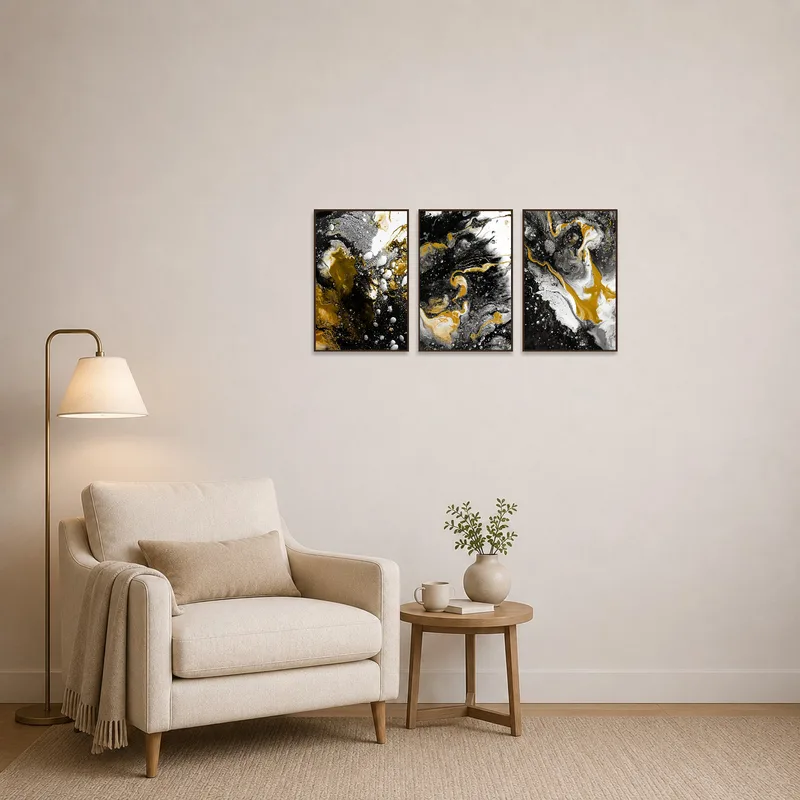 Abstract triptych in gold, black, and white adds elegance to a cozy reading corner.