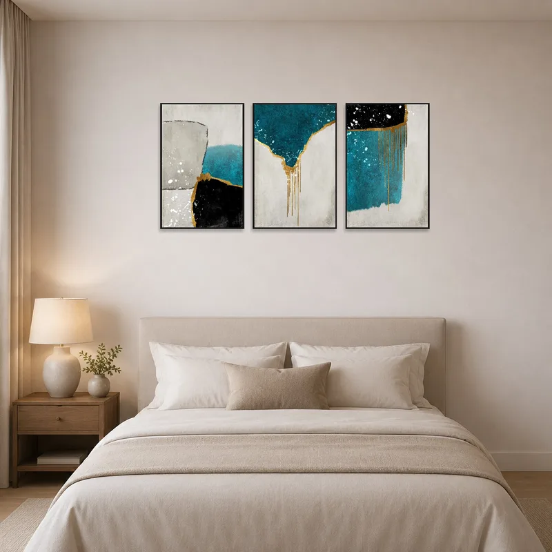 Bedroom wall adorned with an abstract triptych with touches of gold and teal.