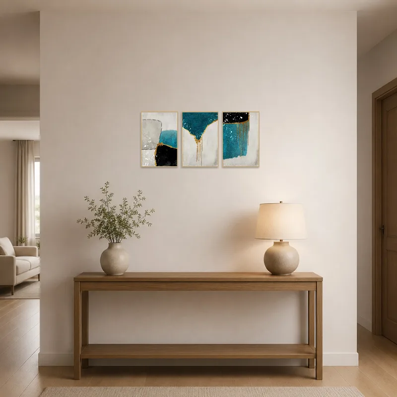 Entrance hall enhanced by an abstract triptych with gold and teal elements.