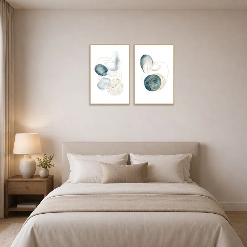 Tranquil bedroom adorned with abstract watercolor art featuring stylish gold touches.