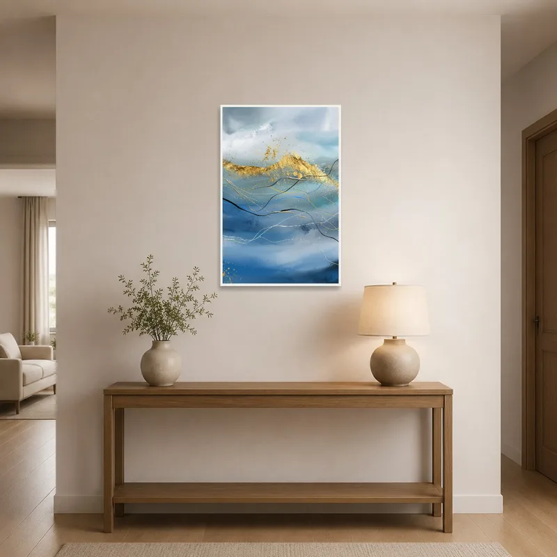 Artwork of abstract waves with gold touches hanging in an entrance hall over a console table.