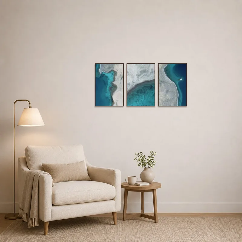 Reading corner adorned with serene aerial coastal prints promoting a tranquil reading atmosphere.