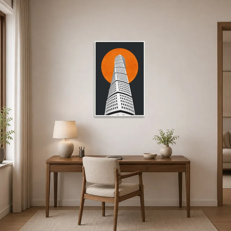 Home office wall displays an art piece of an architectural tower and an orange sun.