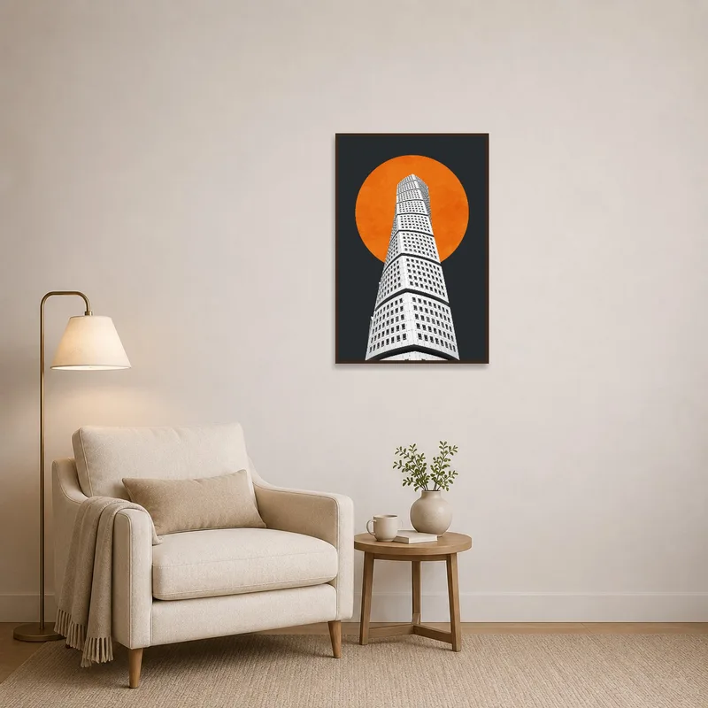 Reading corner adorned with art portraying an architectural tower and an orange sun.