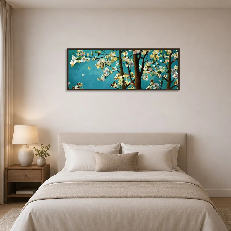 Blossoming tree branches on turquoise lend a peaceful feel to a bedroom setting.
