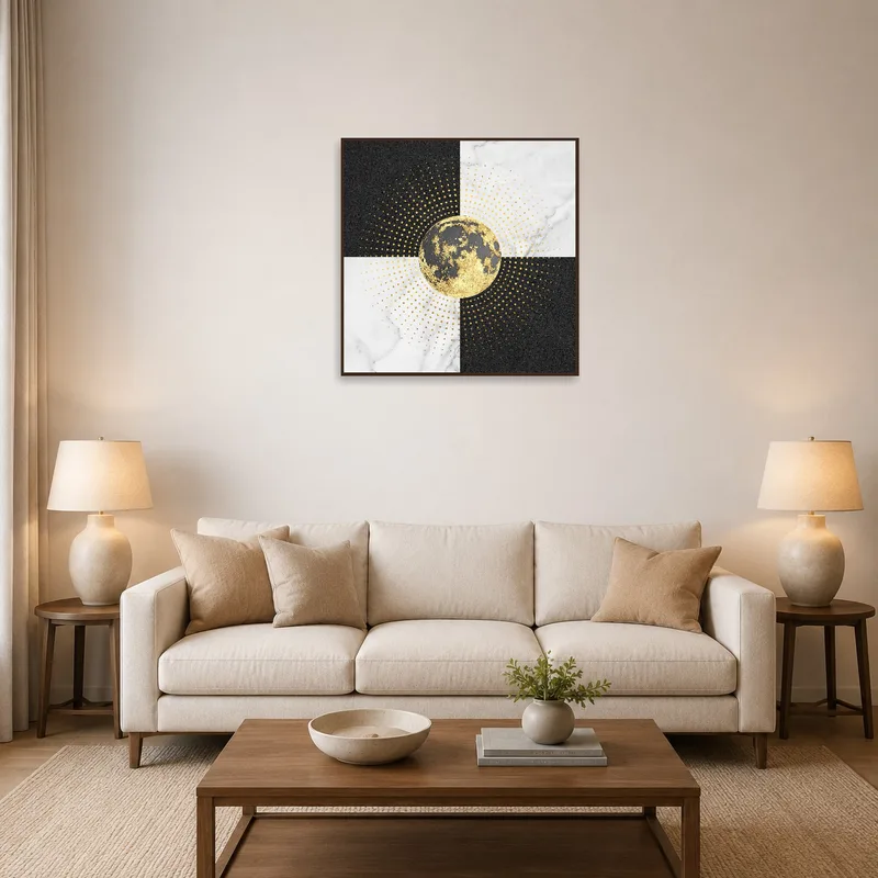 Square print with gold accents on a living room wall beside a modern couch.