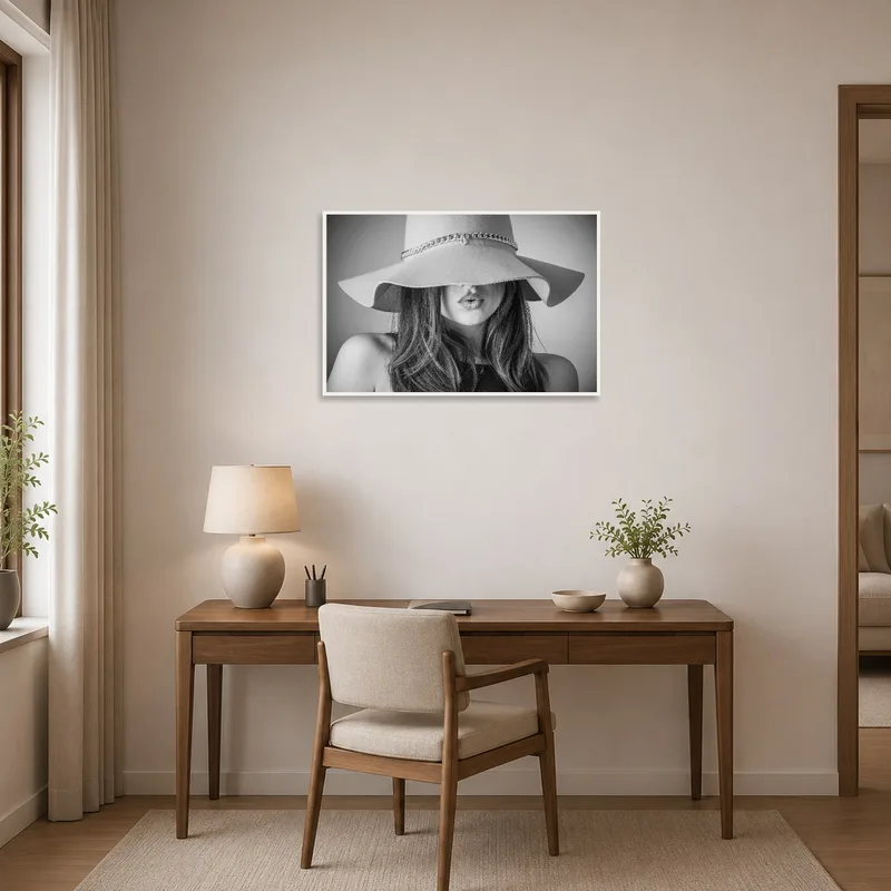 An inspiring monochrome woman in a hat adorns the wall in the home office.