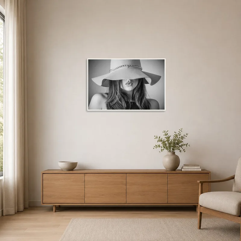 The minimalist room is enhanced by a monochrome portrait of a woman wearing a chic hat.