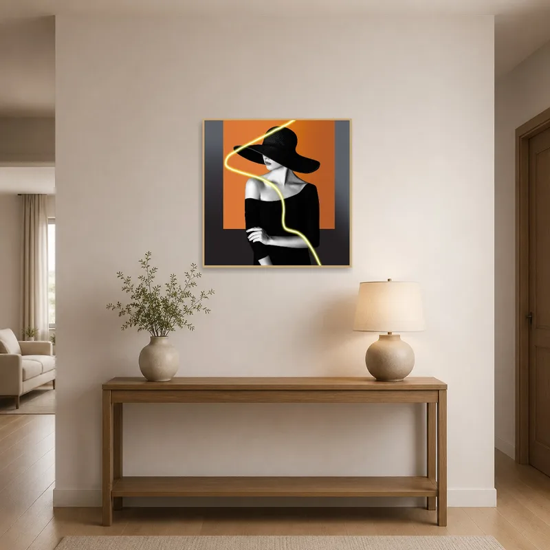 Chic noir portrait with neon accent welcomes guests in the entrance hall.