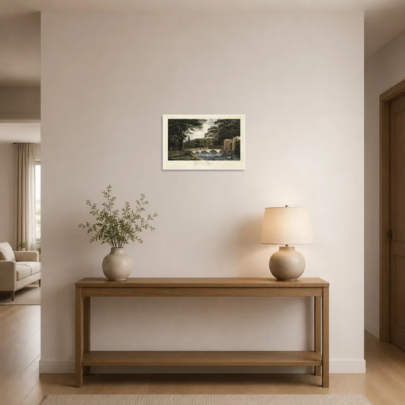 Charming landscape print with a bridge and trees in the entrance hall.