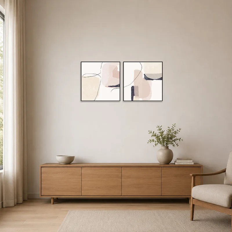 Neutral abstract art pieces complementing a minimalist white space.