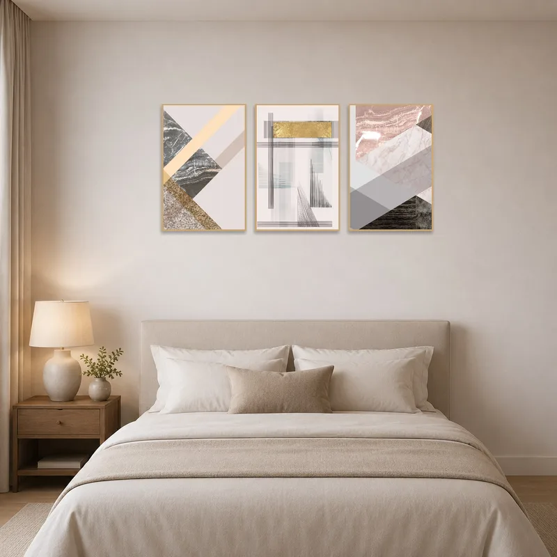 Contemporary geometric abstract triptych art above a bed.