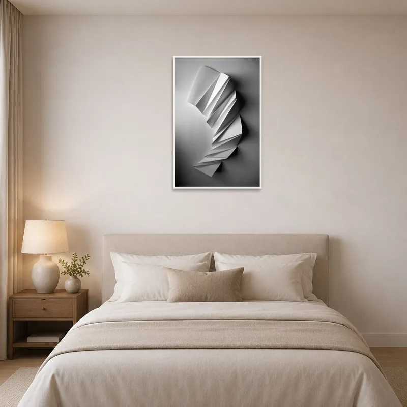 Elegant monochrome paper sculpture print hanging on bedroom wall above bed.