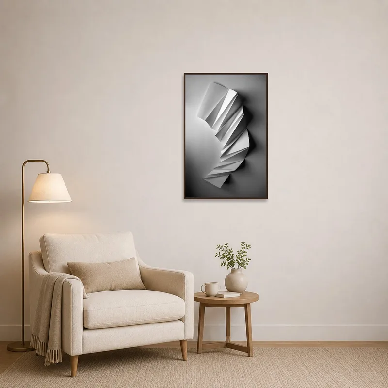 Monochrome paper sculpture print featured on wall beside cozy reading chair.
