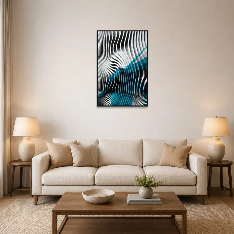 Abstract art of dynamic black and blue waves hanging above a modern sofa in a living room.