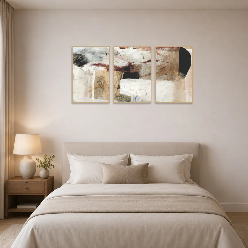 Abstract earthy triptych adding serenity to a serene bedroom.