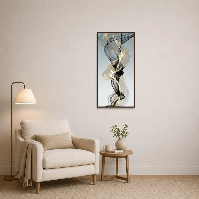 Gold and black abstract artwork near a plush chair in a reading corner