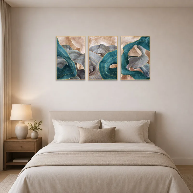 Elegant abstract triptych serving as a focal point above a plush bed in a cozy bedroom.