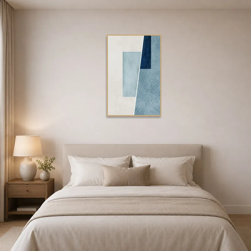 Elegant geometric blue composition above a bed, complementing the tranquil bedroom setting.