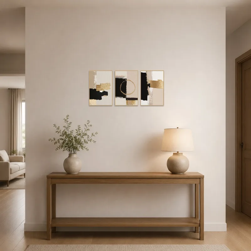 Elegant abstract gold and black triptych set welcomes guests in a stylish entrance hall.