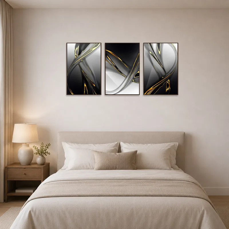 Gold and black abstract triptych creates a focal point above the bed in a serene bedroom.
