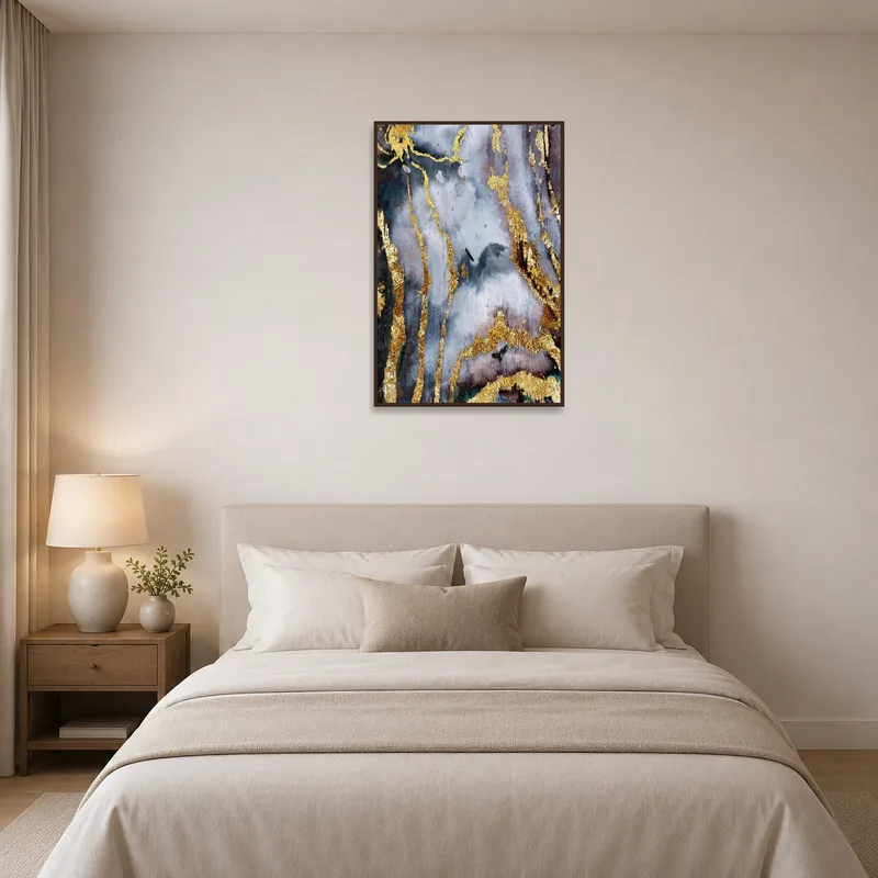 Serene bedroom with chic gold and gray abstract art above the bed.