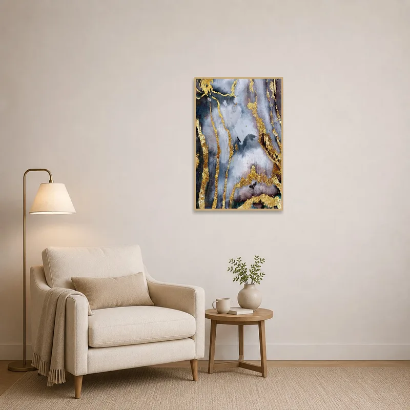 Abstract gold and gray artwork enhancing a cozy reading corner with a comfy chair.