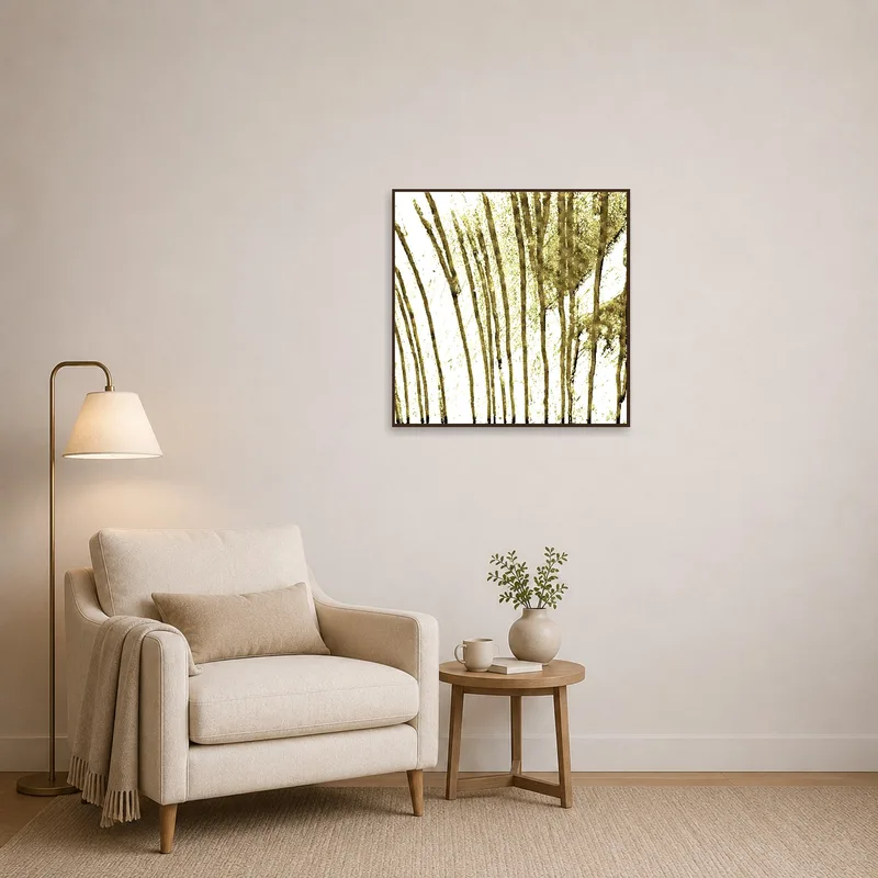 Reading corner with an abstract gold brushstroke art print on the wall beside a cozy armchair.