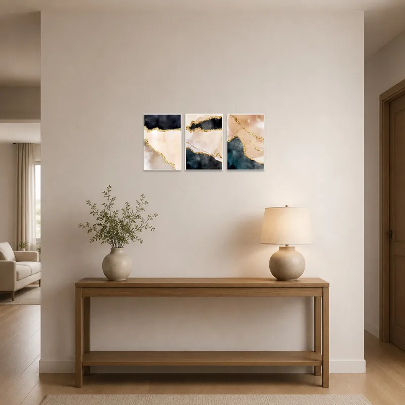 Bold abstract triptych greets visitors in an entrance hall, adding warmth with gold and earth hues.