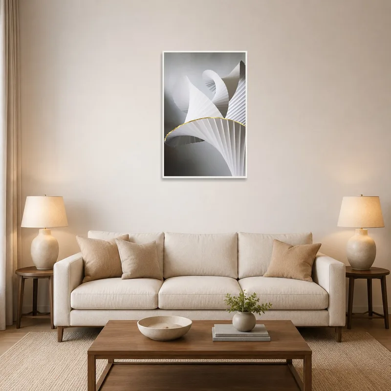 Art print of abstract paper sculptures on a living room wall above a modern sofa.
