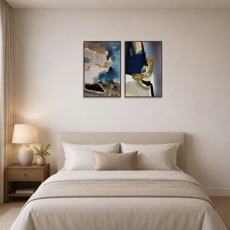Sophisticated abstract art with gold accents above the bed.