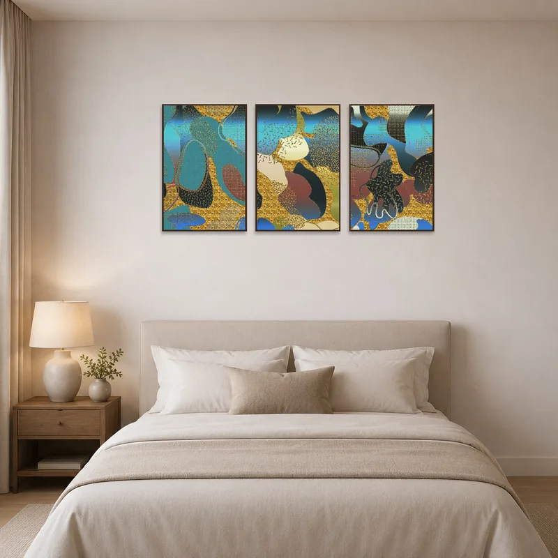 Abstract triptych in calming blue and gold above a bedroom bed.