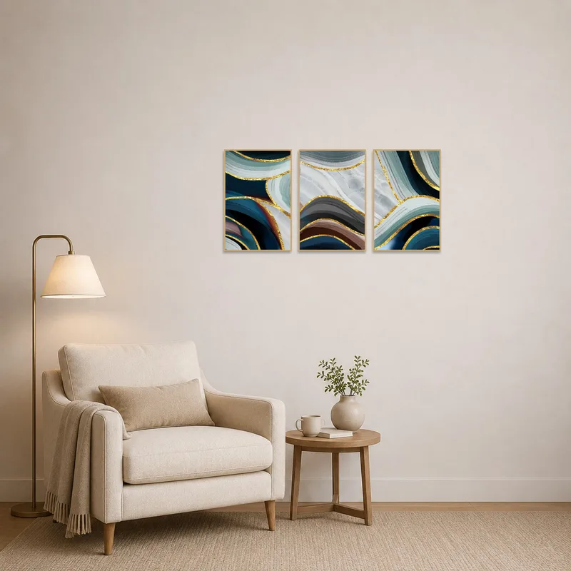 A reading corner featuring an abstract triptych with gold accents.