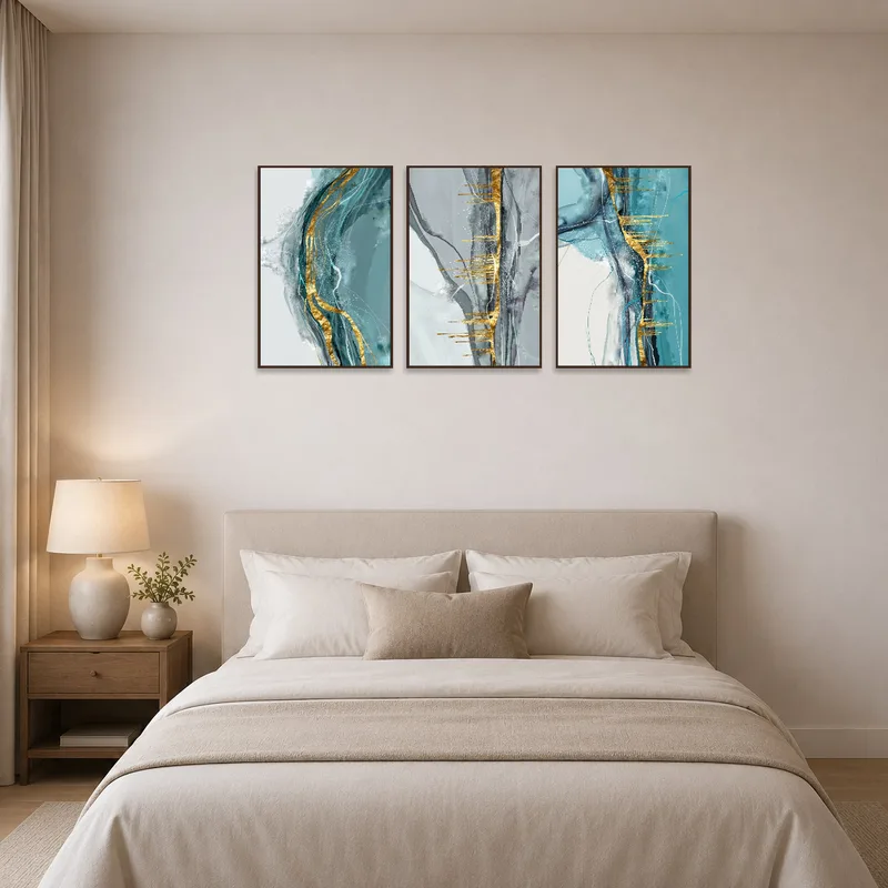 Bedroom wall displaying an elegant abstract triptych with gold highlights.