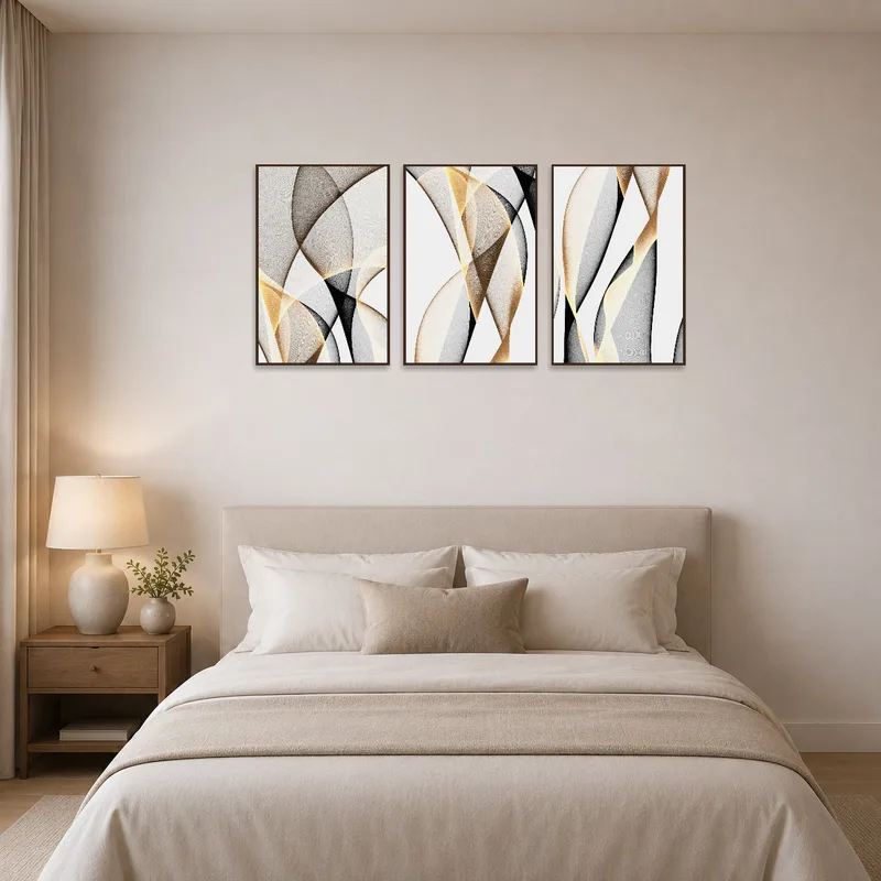 Abstract triptych with organic forms hanging above a bed, adding calming elegance to the bedroom.