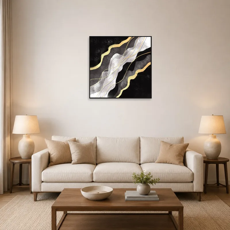 Abstract art with gold accents on a living room wall above a modern sofa.