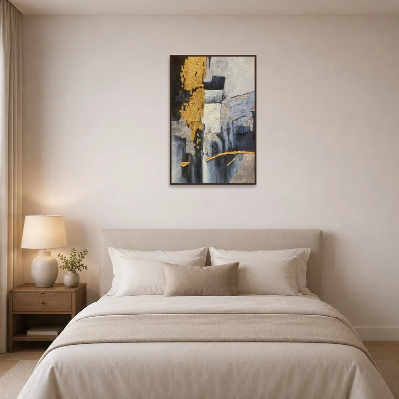 In the bedroom, the abstract artwork with gold and silver textures complements the serene surroundings.