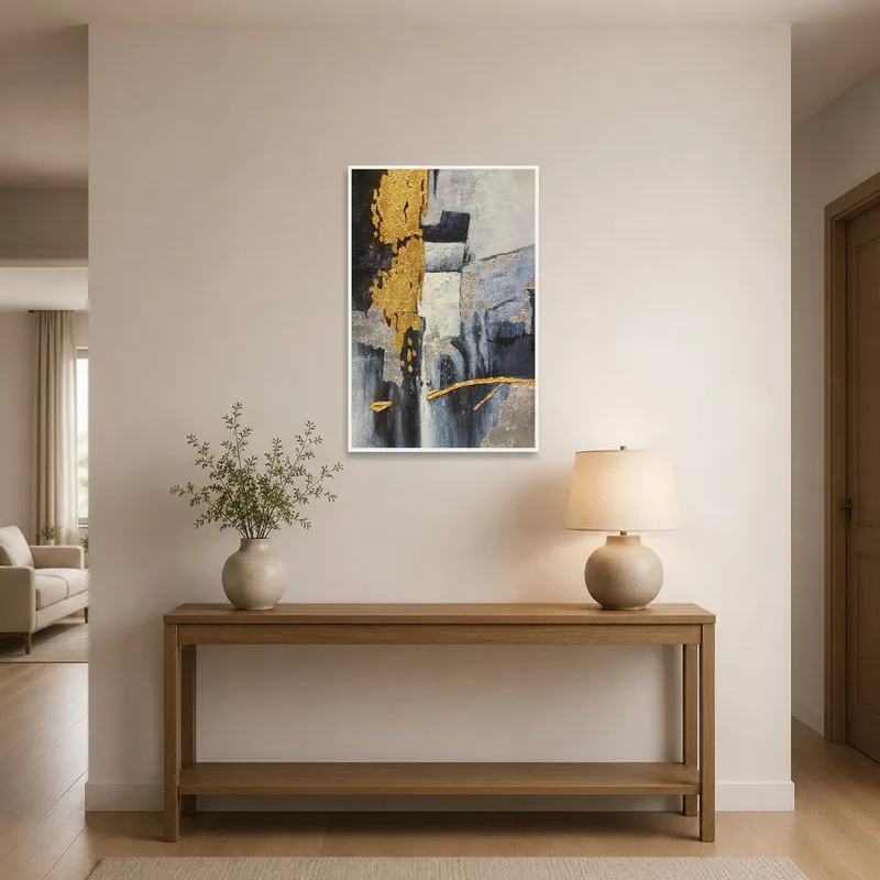 The entrance hall showcases the sophisticated abstract art with gold and silver elements.