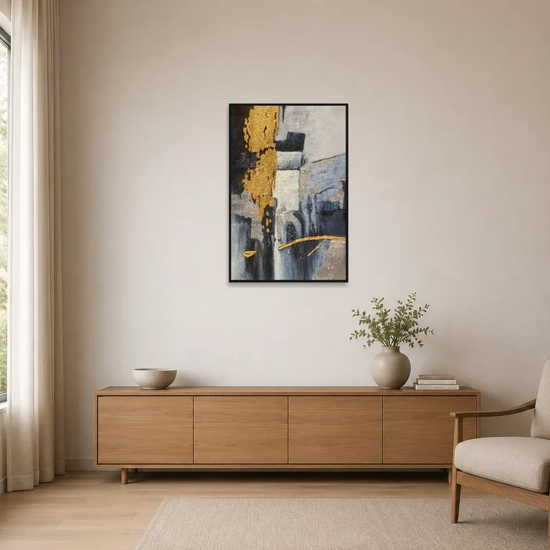 A minimalist room featuring the abstract piece with its gold and silver textures as a focal point.