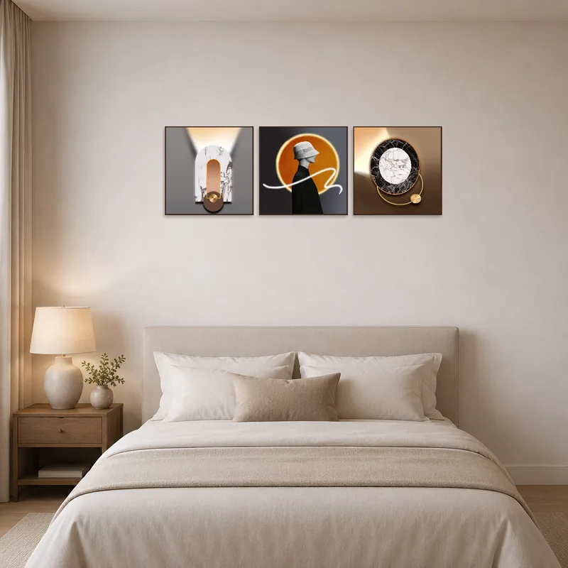 Chic triptych displayed at the head of a tidy, serene bedroom.