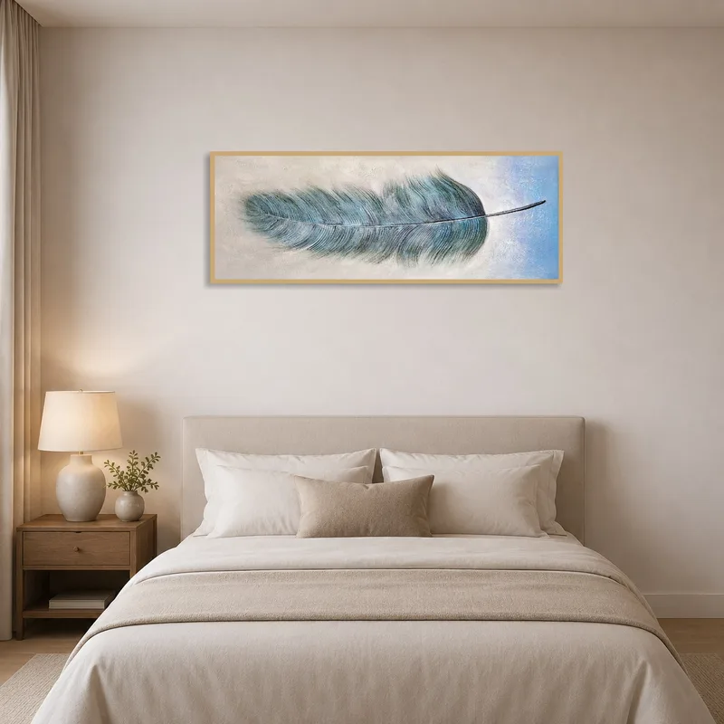 Serene blue feather art enhances the tranquility of a chic bedroom.