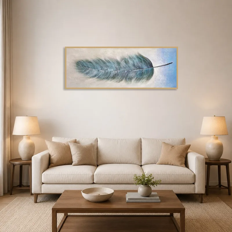 A blue feather art piece hangs in a modern living room above a sleek sofa.