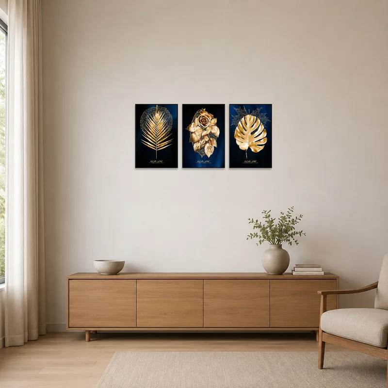 Minimalist room with triptych of golden leaves on a white wall.
