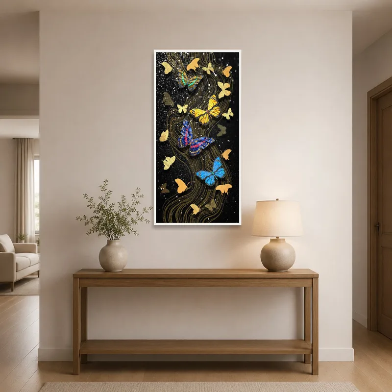 Black and gold butterfly art displayed in an entrance hall above a console table.