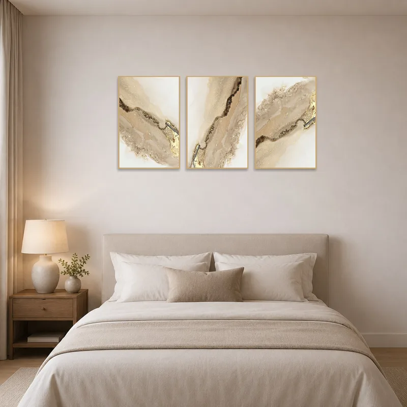 Elegant earth-toned abstract trio enhances bedroom ambiance.