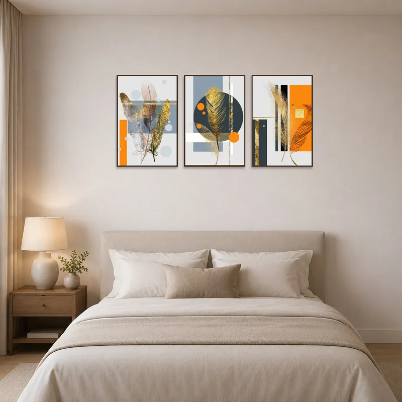 Feather and geometric triptych art enhances the serenity of a bedroom.