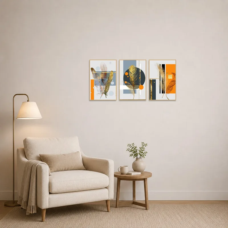 A cozy reading corner features a triptych set of feathers and geometric art.